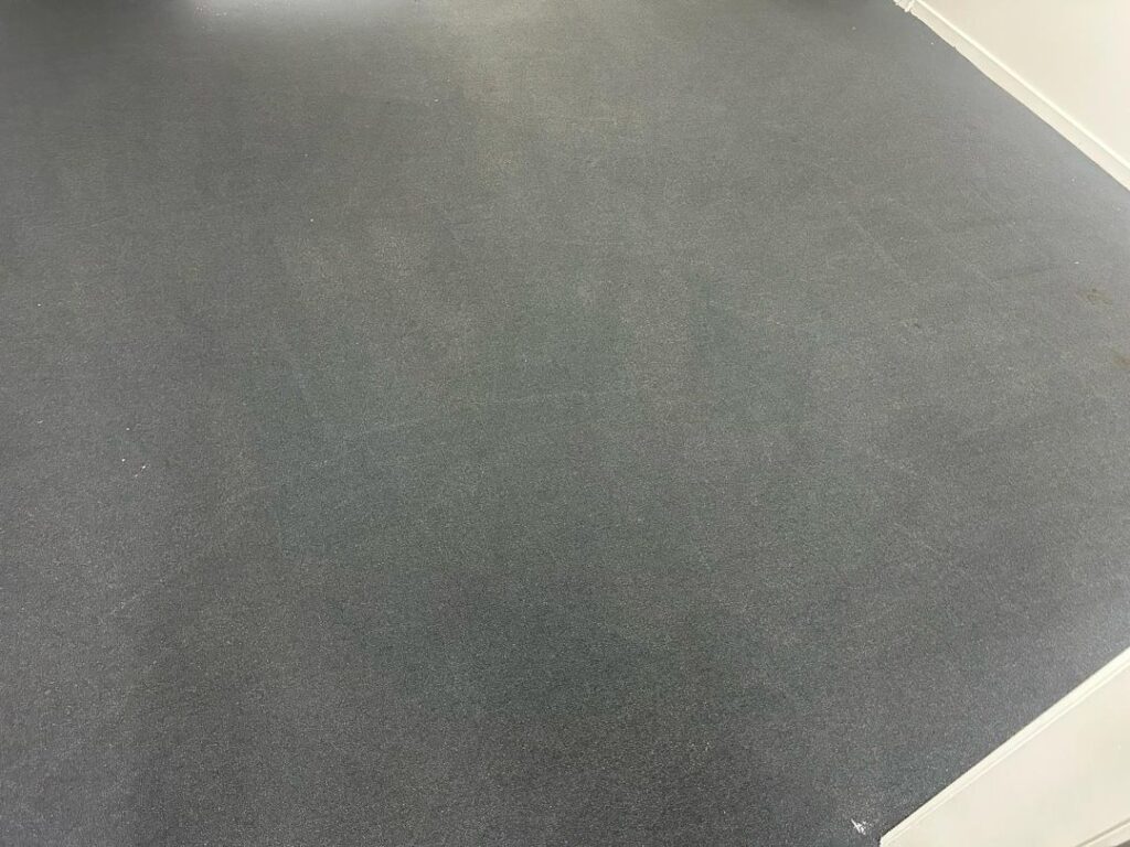 Office Carpet Post-Cleaning in Factory Image of a clean office carpet in a factory setting.